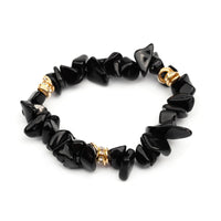 Schwarzes Onyx-Armband mit goldenen Akzenten, Edelstein-Schmuck, modisches Accessoire.