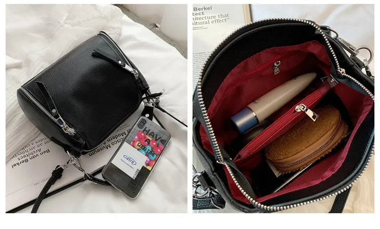 Schwarze Lederhandtasche mit Reißverschluss, Innenfächer, rote Fütterung, Damenmode Accessoire.