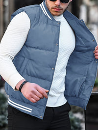 Mann in blauer Steppweste und weißem Pullover, modisch, lässig, Outdoor-Bekleidung.
