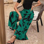Damenhose mit weitem Bein, grün-schwarz, florales Muster, Frühling-Sommer-Mode 2024.