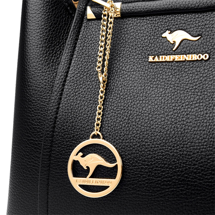 Schwarze Lederhandtasche mit goldener Känguru-Logo-Kette, elegantes Design, Damenmode.