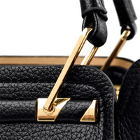 Schwarze Lederhandtasche mit goldenen Metallakzenten, luxuriöses Design, Nahaufnahme.