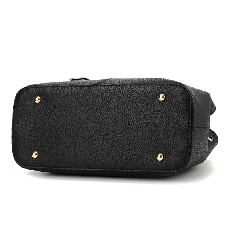 Schwarze Lederhandtasche mit goldenen Nieten, elegante Damenmode, stilvolles Accessoire.
