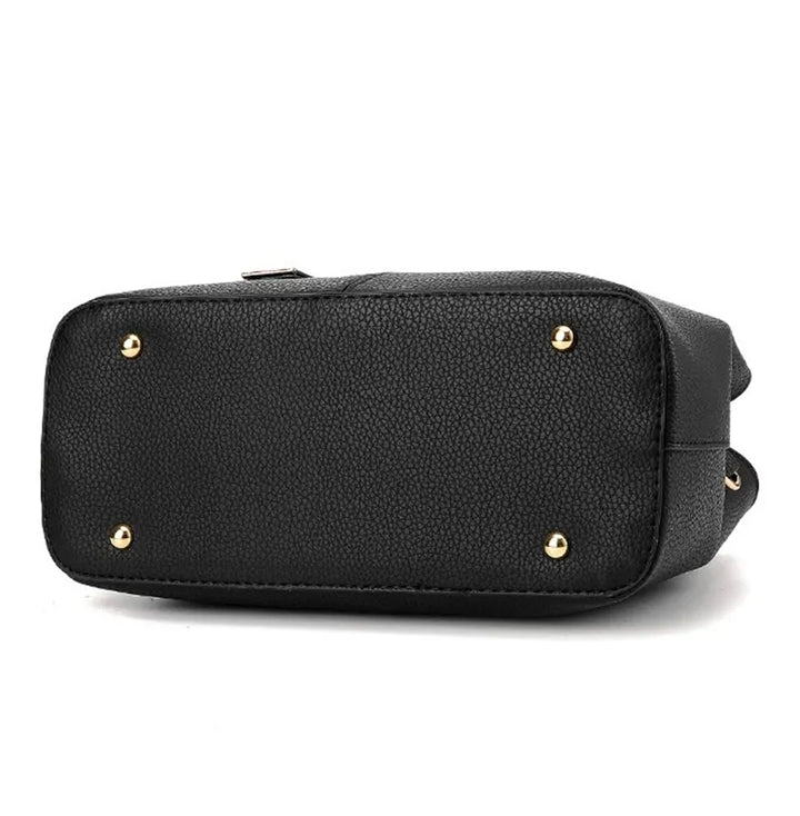 Schwarze Lederhandtasche mit goldenen Nieten, elegante Damenmode, stilvolles Accessoire.