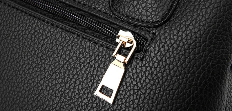 Schwarze Lederhandtasche mit goldfarbenem Reißverschluss, elegante Damenmode Accessoire.