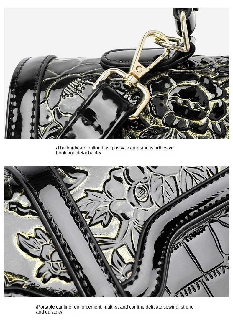 Schwarze Lederhandtasche mit glänzendem Blumenmuster und abnehmbarem goldfarbenem Haken.