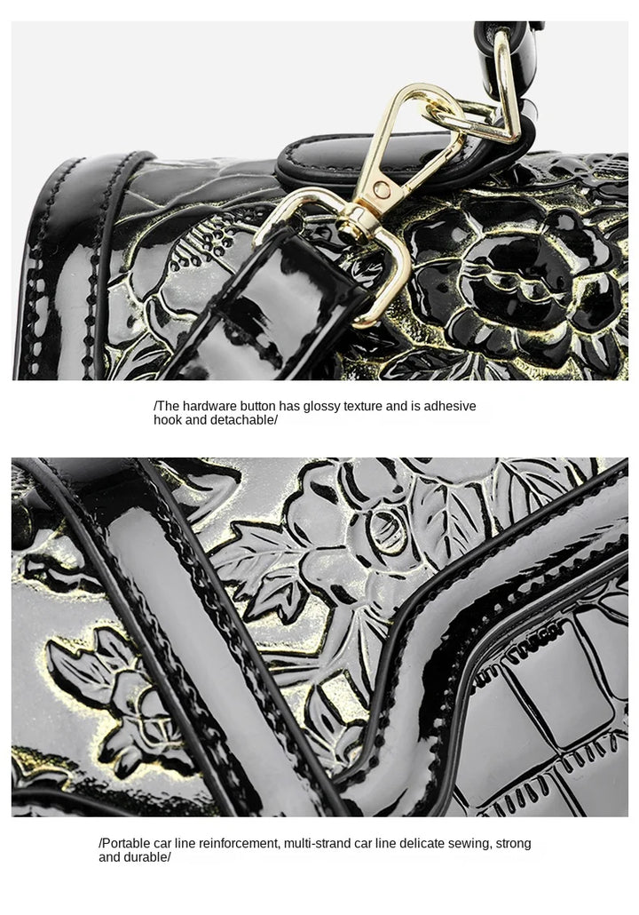 Schwarze Lederhandtasche mit glänzendem Blumenmuster und abnehmbarem goldfarbenem Haken.