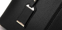 Schwarze Lederhandtasche mit goldenen Details, elegante Damenmode, stilvolles Accessoire.