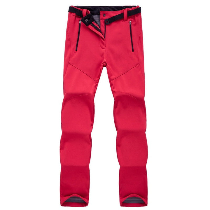 Rote Outdoor-Hose, wasserdicht, mit Reißverschlusstaschen, ideal für Wandern und Trekking.