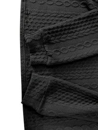 Schwarze, strukturierte Leggings aus Baumwolle mit Zopfmuster, modisch und bequem.