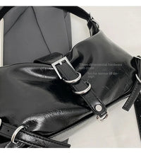 Schwarze Lederhandtasche mit Schnallen, dreidimensionaler Hardware, modisches Design.