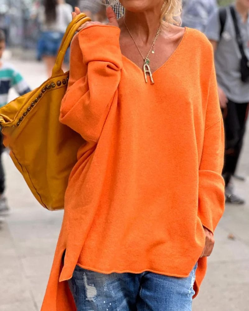 Frau in orangefarbenem Pullover mit gelber Tasche, lässiger Streetstyle, Herbstmode.