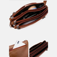 Braune Lederhandtasche mit mehreren Reißverschlussfächern, ideal für Damen, modisch und praktisch.