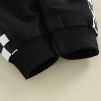 Schwarze Jogginghose mit weißen Karomuster, Bündchen, Baumwolle, sportlich, bequem.