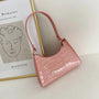 Rosa Krokodilleder-Handtasche, elegant, modisch, Damen-Accessoire, Vintage-Stil.