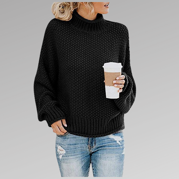 Frau in schwarzem Strickpullover mit Kaffeebecher, lässige Mode, Herbstoutfit, Jeans.