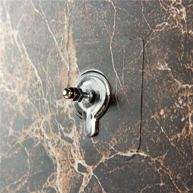 Transparenter Wandhaken auf marmorierter Oberfläche, selbstklebend, wiederverwendbar, robust.