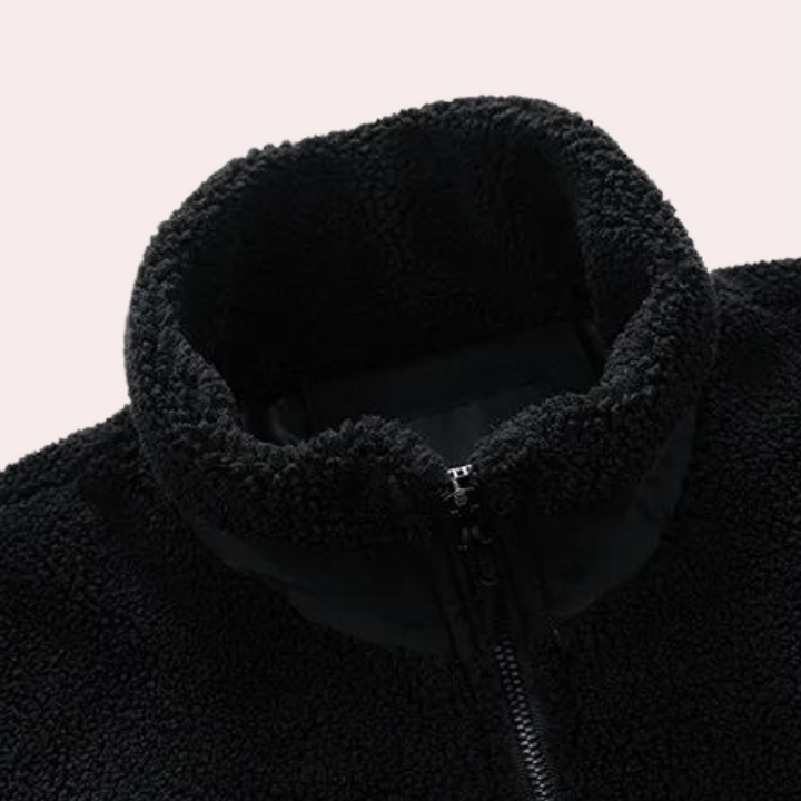 Schwarze Fleecejacke mit Reißverschluss, hoher Kragen, weiches Material, warme Winterbekleidung.
