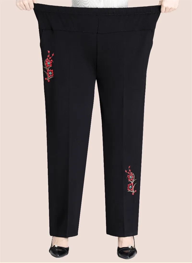 Schwarze Damenhose mit rotem Stickmuster, elastischer Bund, elegant, bequem.