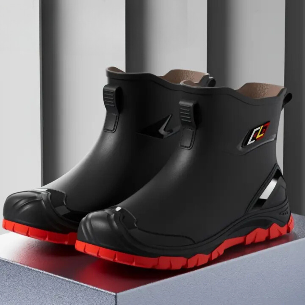 Schwarze Gummistiefel mit roter Sohle, wasserdicht, rutschfest, für Outdoor-Aktivitäten.