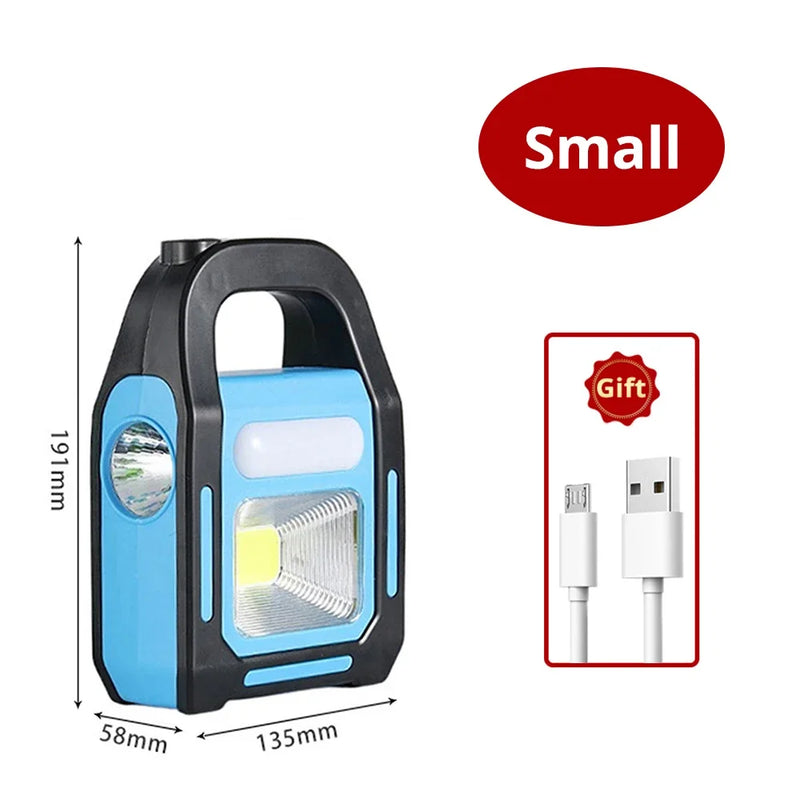 Tragbare blaue LED-Campinglampe mit USB-Ladekabel, kompakt, ideal für Outdoor-Abenteuer.