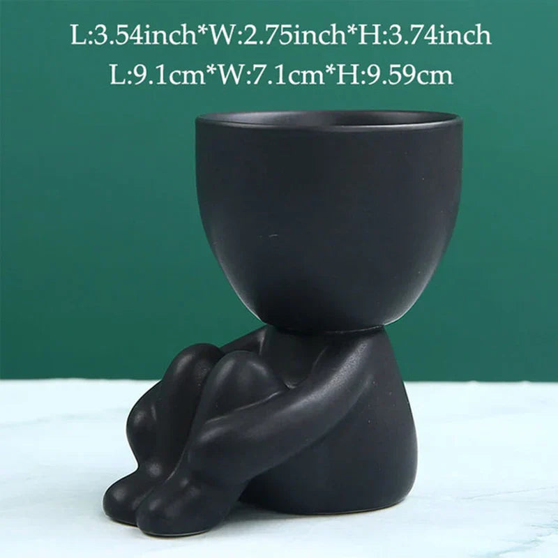 Schwarzer Keramik-Blumentopf in menschlicher Form, modern, dekorativ, für Innenräume.