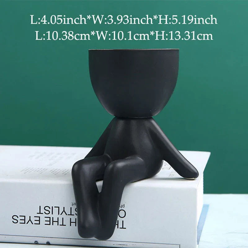 Schwarzer Keramik-Blumentopf in menschlicher Form, modern, dekorativ, für Innenräume.