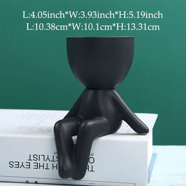 Schwarzer Keramik-Blumentopf in menschlicher Form, modern, dekorativ, für Innenräume.