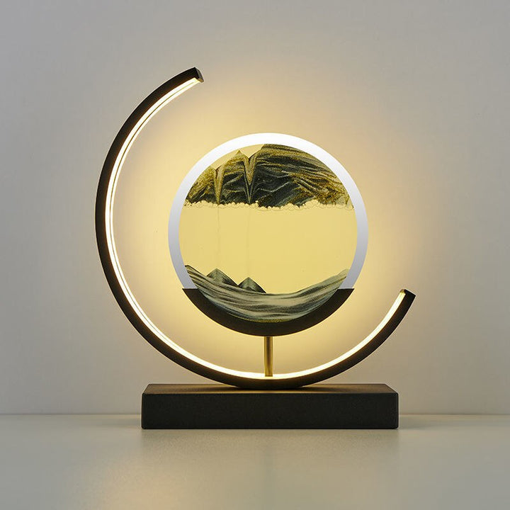 Moderne Sanduhrlampe mit LED-Beleuchtung, schwarz-gold, dekorative Tischleuchte, rundes Design.