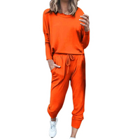 Frau in orangefarbenem Jogginganzug, lässig, bequem, Freizeitmode, Sportbekleidung.