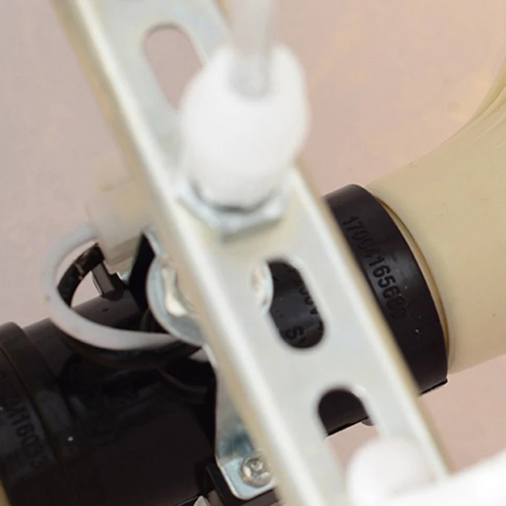 Nahaufnahme einer weißen Metallhalterung mit Kunststoffteilen und Schrauben, industrielle Anwendung.