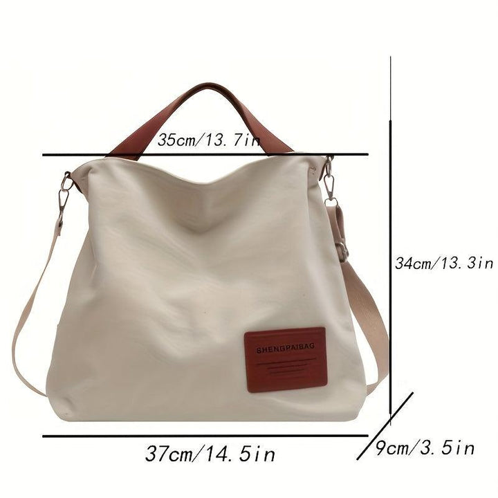 Beige Canvas Schultertasche mit braunen Griffen, lässig, geräumig, modisch, Damenaccessoire.