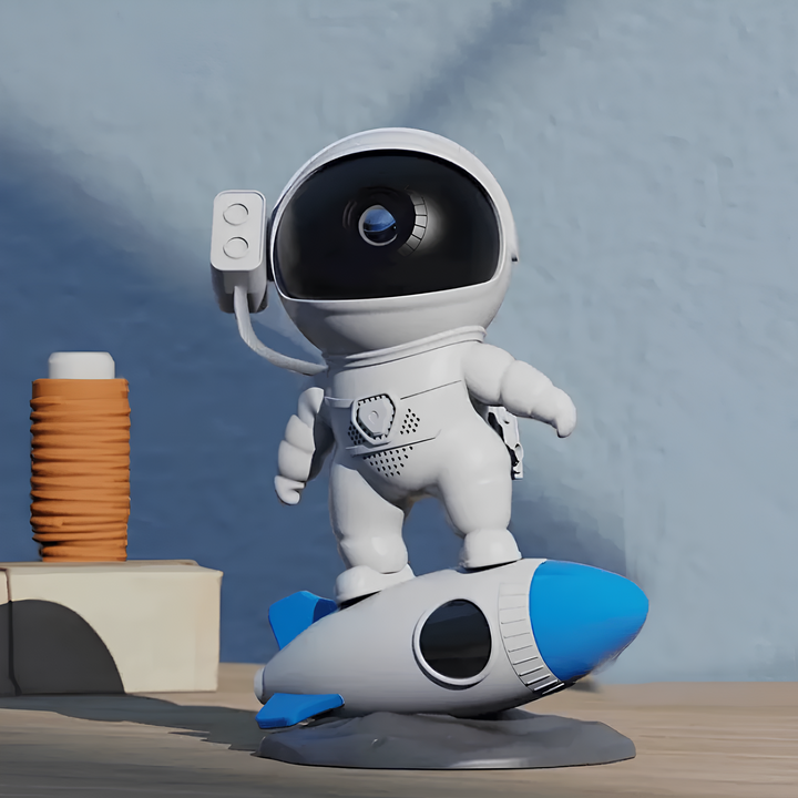 Weißer Astronaut-Spielzeug auf blauem Raketen-Modell, Kinderzimmer-Dekoration, Kunststoff.