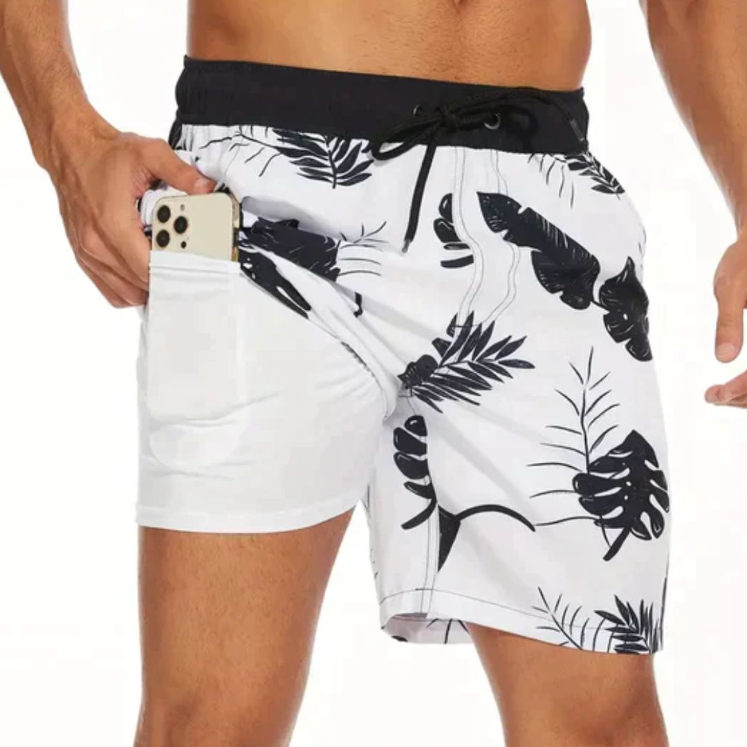 Herren-Badeshorts mit tropischem Muster, weiß-schwarz, Handyfach, Strandmode.