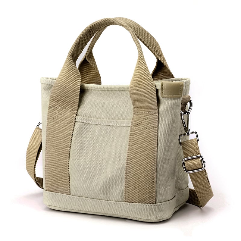 Beige Canvas-Handtasche mit Schulterriemen, modisch, robust, ideal für Alltag und Reisen.