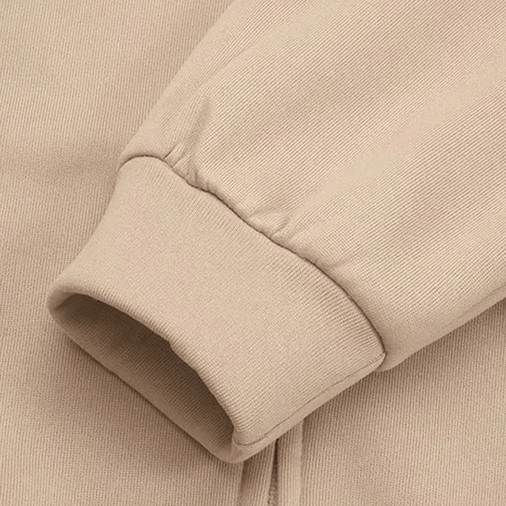 Beiger Baumwollpullover-Ärmel, geripptes Bündchen, weiches Material, modische Freizeitkleidung.