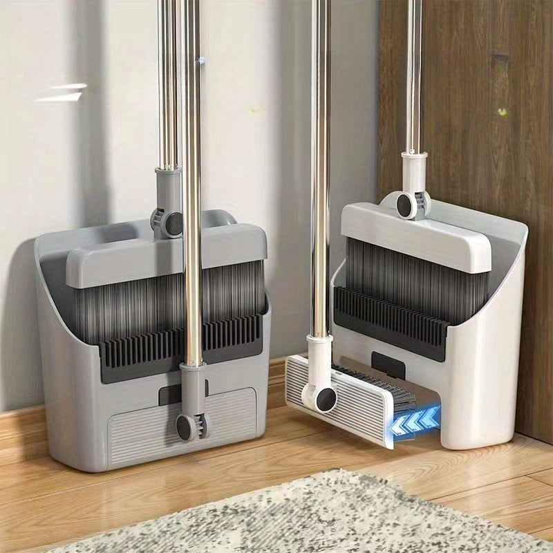 Grauer Kehrset mit Besen und Kehrschaufel, platzsparend, für Haushalt, auf Holzboden.