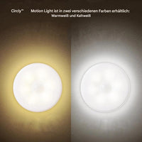 Zwei runde LED-Bewegungslampen, warmweiß und kaltweiß, auf dunklem Hintergrund.