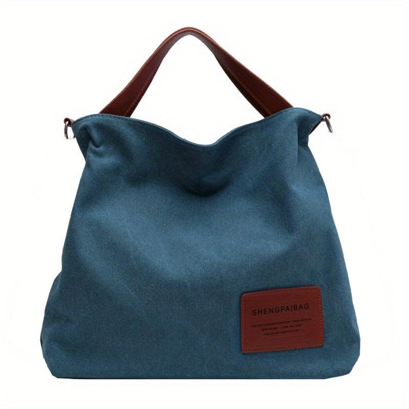 Blaue Canvas-Schultertasche mit braunen Griffen, lässig, modisch, Damenhandtasche.