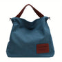 Blaue Canvas-Schultertasche mit braunen Griffen, lässig, modisch, Damenhandtasche.