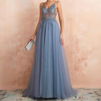 Frau in blauem Abendkleid mit Spitze, hält silberne Clutch, elegantes Design, Abendmode.