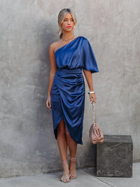 Frau in blauem, einarmigem Satin-Kleid, elegantes Design, modisches Abendoutfit.