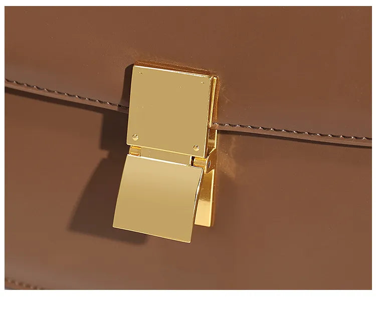 Braune Ledertasche mit goldener Metallschnalle, elegante Damenhandtasche, modisches Accessoire.