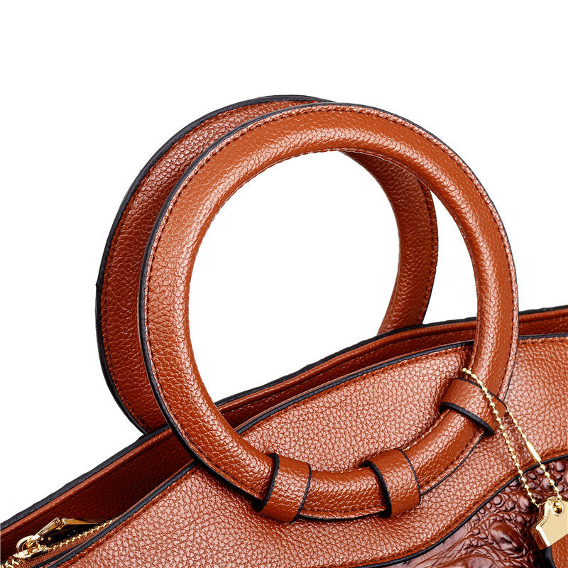 Braune Lederhandtasche mit runden Griffen, elegantes Design, Damenmode-Accessoire.