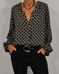 Damenbluse mit geometrischem Muster, schwarz-gold, V-Ausschnitt, lässig, modisch, elegant.