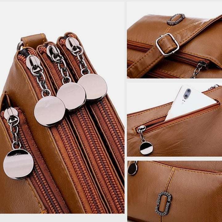 Braune Leder-Umhängetasche mit mehreren Reißverschlüssen und Smartphone-Fach.