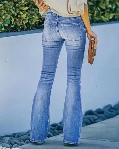 Frau in blauer Schlaghose aus Denim, Rückansicht, hält braune Clutch, lässiger Stil.