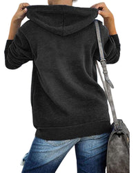 Person in schwarzem Hoodie und blauer Jeans mit grauer Umhängetasche von hinten.