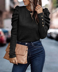 Frau in schwarzem Pullover mit Rüschenärmeln, blaue Jeans, beige Clutch, Stadtstraße.