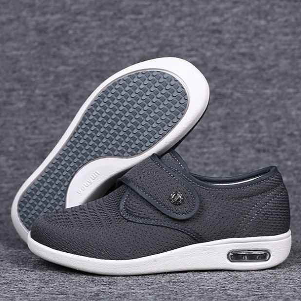 Graue orthopädische Schuhe mit Klettverschluss, rutschfeste Sohle, bequem, atmungsaktiv.